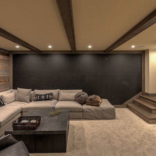 Photo of a large rustic fully buried basement in Other with brown walls, porcelain flooring, a hanging fireplace, a tiled fireplace surround and grey floors.