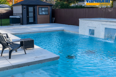 Example of a mid-sized transitional backyard concrete and l-shaped pool fountain design in Montreal