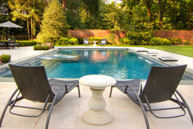 Example of a classic backyard rectangular natural hot tub design in New York