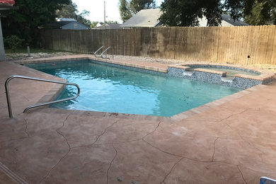 Pool - mid-sized contemporary backyard stamped concrete and custom-shaped lap pool idea in Tampa