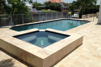 Design ideas for a large transitional backyard rectangular lap pool in Other with a hot tub and tile.