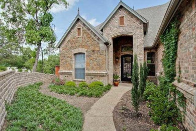 Inspiration for a large craftsman beige two-story mixed siding house exterior remodel in Dallas with a clipped gable roof and a shingle roof
