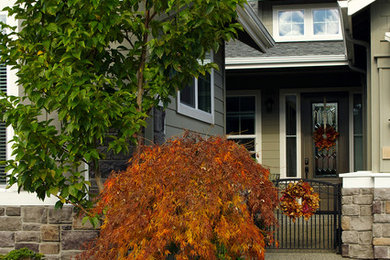 This is an example of a mid-sized craftsman full sun front yard driveway in Seattle.