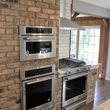 Atkinson, IL- Ranch Home Remodel With Bright White Cabinets and Brick Wall