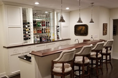 Example of a mid-sized trendy wet bar design in Omaha with white cabinets