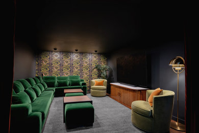 Large minimalist look-out vinyl floor, brown floor and wallpaper basement photo in Portland with black walls and a home theater