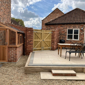 Raised Patio With Sleeper Edging and Linear Drainage