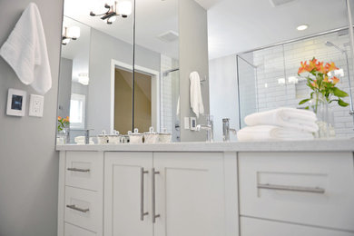 Inspiration for a transitional master glass tile bathroom remodel in Other with shaker cabinets, an undermount sink and quartzite countertops
