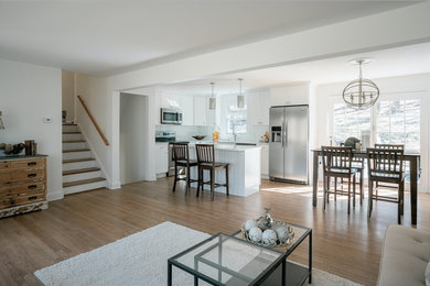 Mid-sized transitional formal and open concept medium tone wood floor and brown floor living room photo in Bridgeport with white walls, no fireplace and no tv