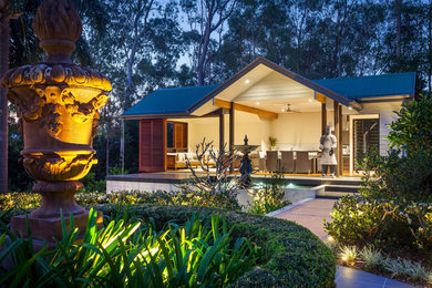 Inspiration for an asian patio in Brisbane with a gazebo/cabana and a water feature.