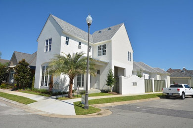 Mid-sized coastal white two-story gable roof idea in New Orleans