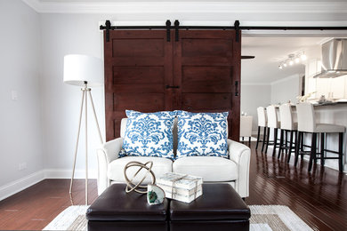 Small transitional enclosed brown floor family room photo in Chicago with gray walls and a tv stand