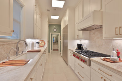 Example of a small transitional galley eat-in kitchen design in Houston with shaker cabinets and white cabinets