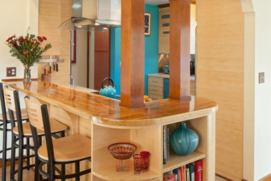 Enclosed kitchen - transitional linoleum floor enclosed kitchen idea in Portland with flat-panel cabinets, light wood cabinets, wood countertops and stainless steel appliances
