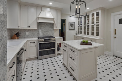 Large elegant marble floor and white floor enclosed kitchen photo in Chicago with an undermount sink, recessed-panel cabinets, white cabinets, marble countertops, gray backsplash, porcelain backsplash, black appliances, an island and white countertops