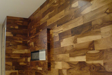 Example of a large minimalist porcelain tile family room design in Chicago with brown walls, a two-sided fireplace and a wood fireplace surround