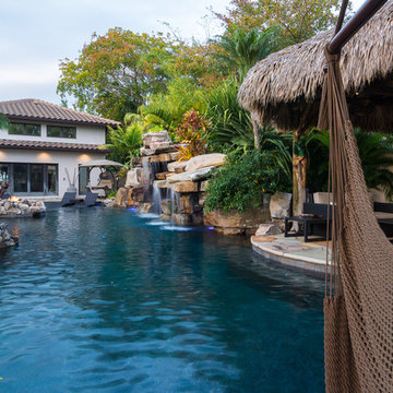 Custom Rock Waterfall Pool with Stone Grotto, Stream and Tiki Hut