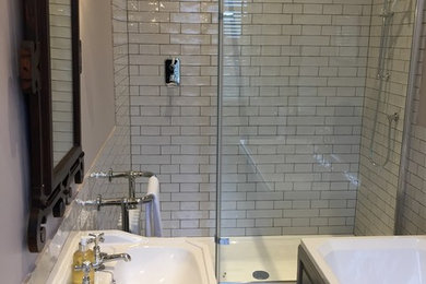 Photo of a large victorian ensuite bathroom in Cornwall with shaker cabinets, grey cabinets, a built-in bath, a walk-in shower, a two-piece toilet, white tiles, ceramic tiles, beige walls, porcelain flooring, a built-in sink and laminate worktops.