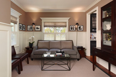 Mid-sized trendy enclosed medium tone wood floor family room photo in Detroit with beige walls