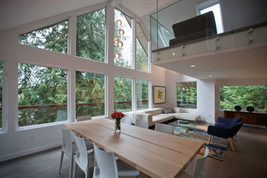 Example of a huge trendy open concept medium tone wood floor living room design in Vancouver with white walls