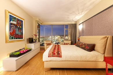 Example of a mid-sized trendy master light wood floor and beige floor bedroom design in Seattle with beige walls and no fireplace