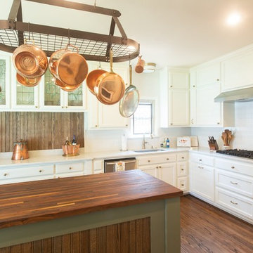 We used an existing gas cooktop and used a simple stainless vent hood to compli