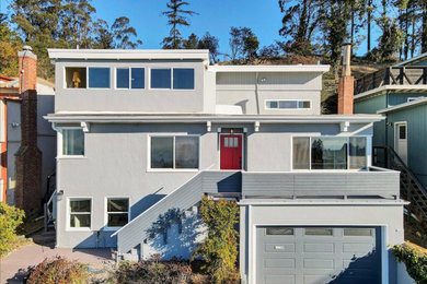 Inspiration for a contemporary exterior home remodel in San Francisco with a mixed material roof and a white roof
