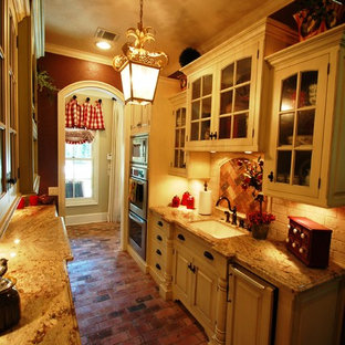 Design ideas for an eclectic galley kitchen pantry in Houston with a drop-in sink, beaded inset cabinets, white cabinets, granite benchtops, white splashback, subway tile splashback, panelled appliances and brick floors.