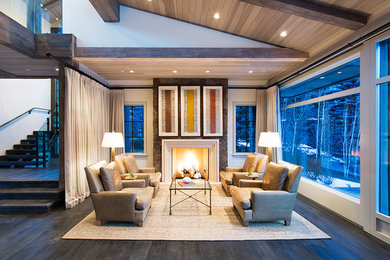 Example of a large trendy open concept and formal dark wood floor and brown floor living room design in Denver with white walls, a standard fireplace, a stone fireplace and no tv