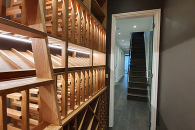 Inspiration for a small wine cellar in London with storage racks.