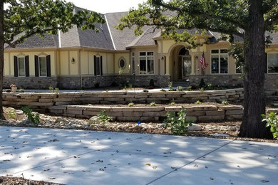 This is an example of a mid-sized rustic front yard retaining wall landscape in Milwaukee.