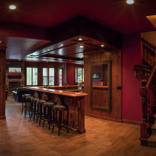 Große Mediterrane Hausbar in L-Form mit Bartheke, Kassettenfronten, dunklen Holzschränken, Arbeitsplatte aus Holz, dunklem Holzboden, Unterbauwaschbecken, bunter Rückwand und brauner Arbeitsplatte in Salt Lake City