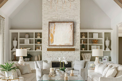 Inspiration for a transitional living room remodel in Little Rock with gray walls, a standard fireplace and a stone fireplace