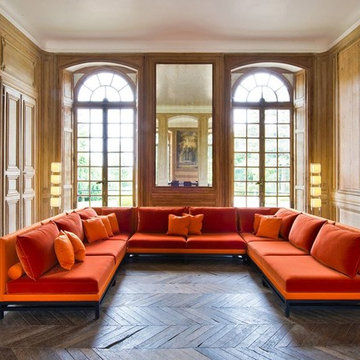 Grand, high ceilinged space with JNL orange modular sofa