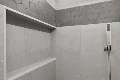 Example of a large minimalist master gray tile and porcelain tile porcelain tile and gray floor bathroom design in Phoenix with a niche