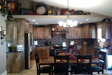 Example of a mid-sized classic u-shaped porcelain tile open concept kitchen design in Other with an undermount sink, raised-panel cabinets, medium tone wood cabinets, granite countertops, brown backsplash, stainless steel appliances and an island
