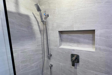 Corner shower - contemporary beige tile and porcelain tile corner shower idea in Toronto