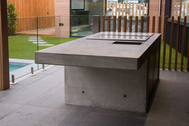 Mid-sized contemporary backyard patio in Geelong with an outdoor kitchen and a roof extension.