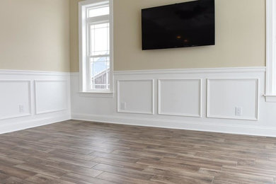 Example of a mid-sized trendy formal and enclosed porcelain tile and beige floor living room design in New York with beige walls and a wall-mounted tv