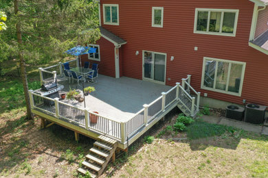 Example of a large arts and crafts backyard second story mixed material railing deck design in New York with no cover