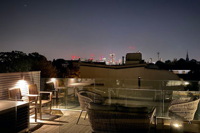 Inspiration for a small modern roof rooftop glass railing terrace in London with feature lighting and a roof extension.
