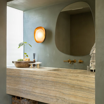 Custom Vanity with Warm Wood Finish and Sculptural Lighting