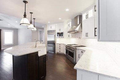 Inspiration for a large transitional medium tone wood floor eat-in kitchen remodel in Other with an undermount sink, shaker cabinets, white cabinets, quartzite countertops, white backsplash, subway tile backsplash, stainless steel appliances and an island