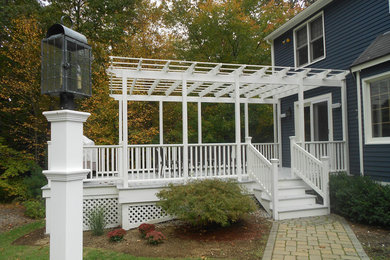 Inspiration for a mid-sized transitional side yard deck remodel in Boston with a roof extension