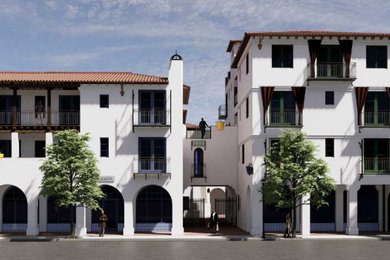Huge tuscan white split-level stucco apartment exterior photo in Santa Barbara with a tile roof and a red roof