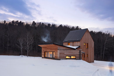 Inspiration for a small rustic brown two-story wood exterior home remodel in New York with a metal roof