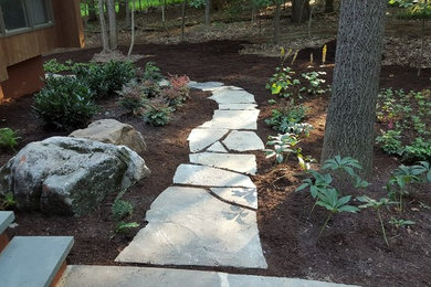 Inspiration for a mid-sized traditional full sun backyard stone landscaping in Baltimore.