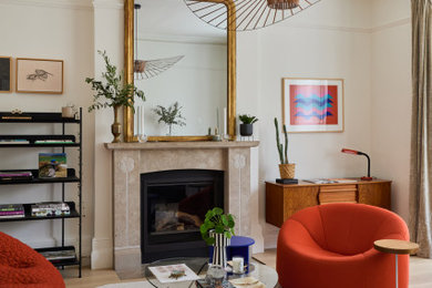Medium sized eclectic formal living room in London with white walls, light hardwood flooring, a standard fireplace, a stone fireplace surround, beige floors and feature lighting.