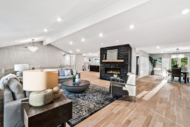 Inspiration for a large contemporary open concept light wood floor living room remodel with gray walls, a ribbon fireplace and a stone fireplace