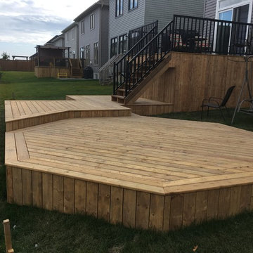 Multiple levels deck with a storage space and a hut-tub place